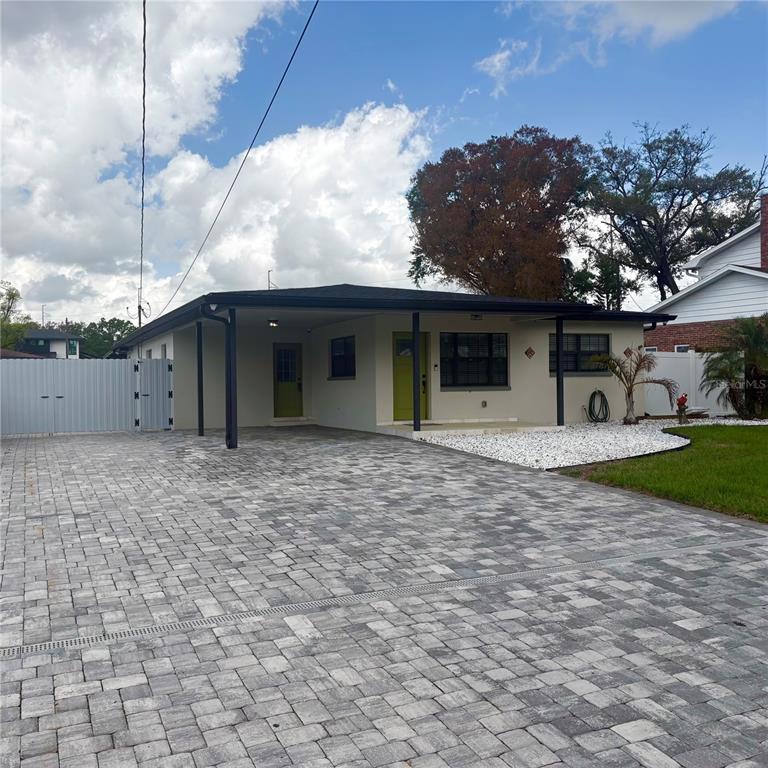 1713 West St Isabel Street Tampa, FL 33607 - Photo 1 of 25 a view of a house with a backyard and a tree