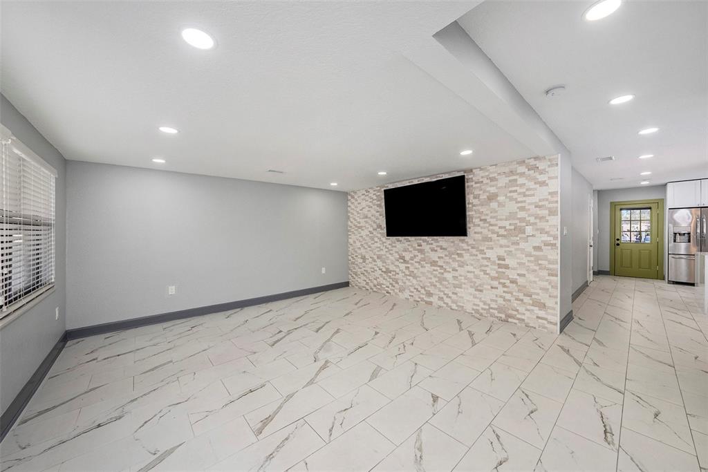 1713 West St Isabel Street Tampa, FL 33607 - Photo 16 of 25 a view of an empty room with a flat screen tv