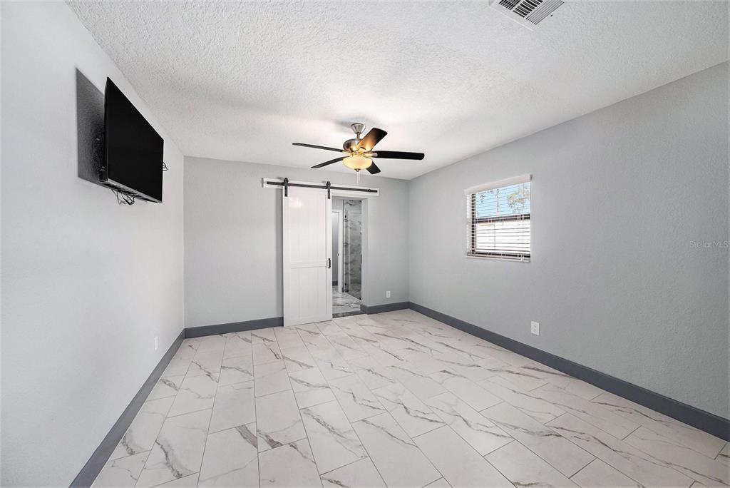 1713 West St Isabel Street Tampa, FL 33607 - Photo 8 of 25 a view of a livingroom with an empty space a ceiling fan and window