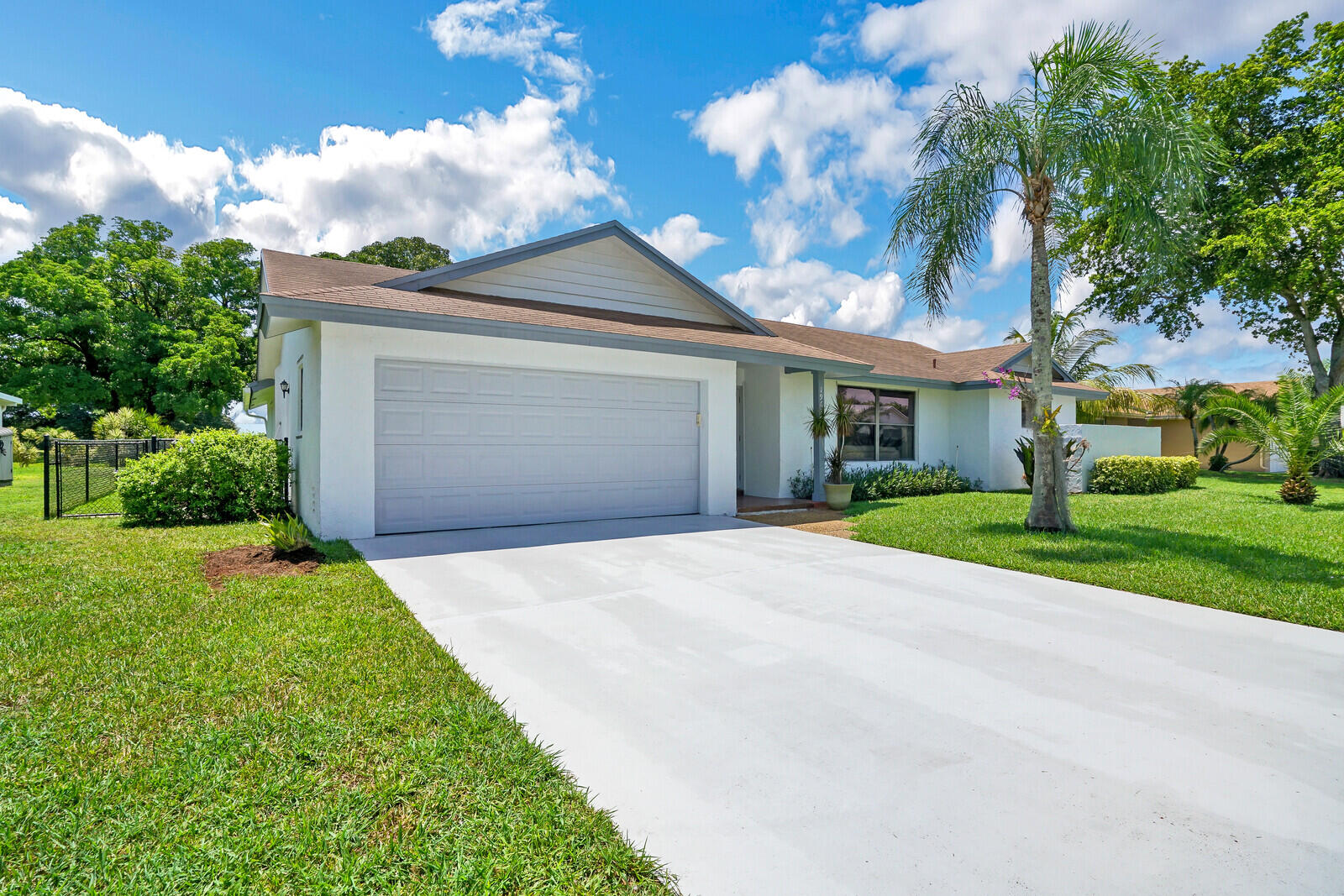19620 Hampton Drive Boca Raton, FL 33434 - Photo 11 of 45 a front view of a house with a yard and garage