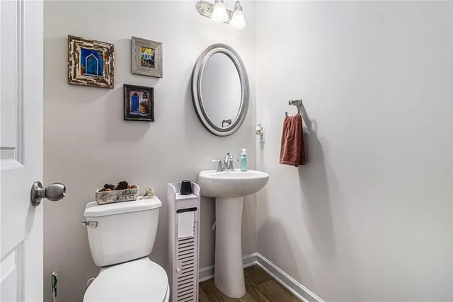 a bathroom with a toilet a sink and a mirror