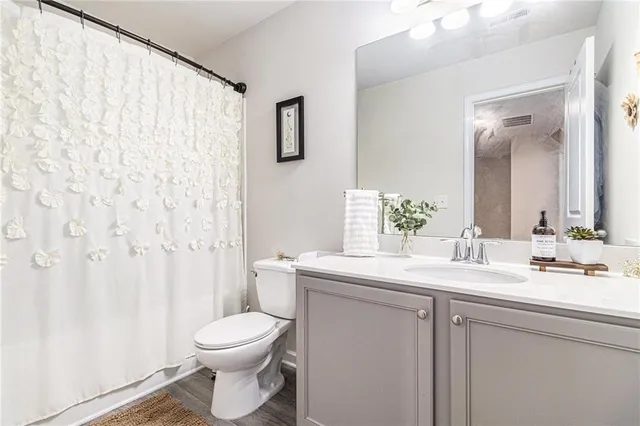 a bathroom with a toilet a sink and a mirror