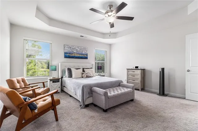 a spacious bedroom with a bed and a couch