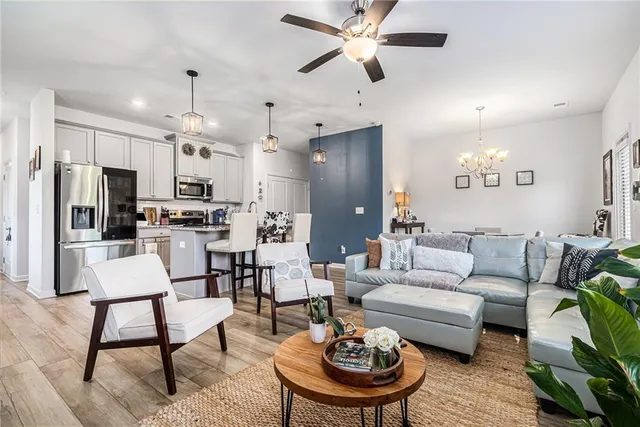 a living room with furniture and kitchen view