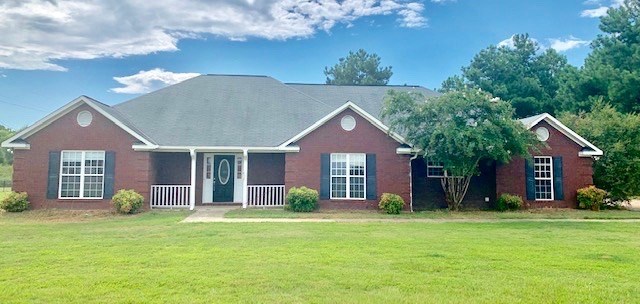 92 McLendon Road Fort Mitchell, AL 36856 - Photo 2 of 16 a front view of a house with a garden