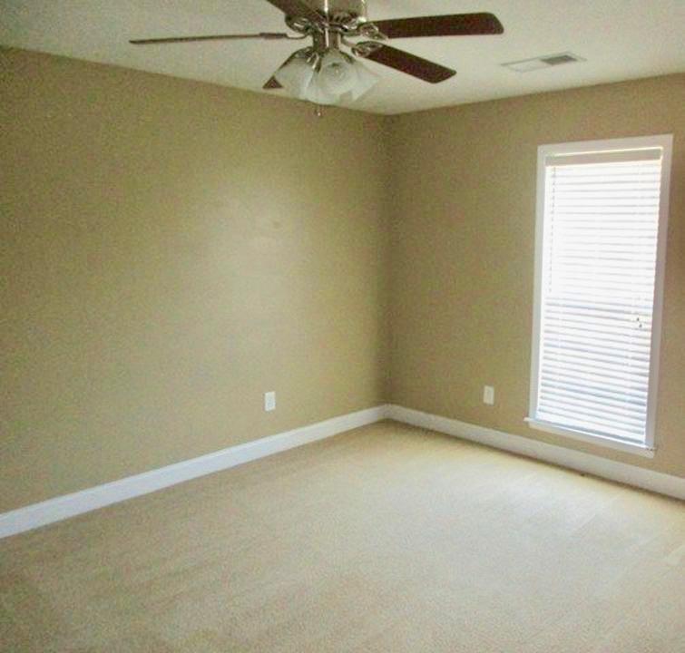92 McLendon Road Fort Mitchell, AL 36856 - Photo 8 of 16 an empty room with a window and a fan