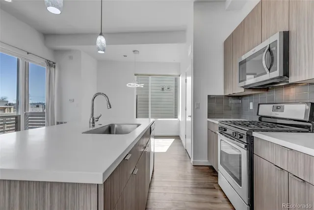 a kitchen with a stove a sink and a microwave