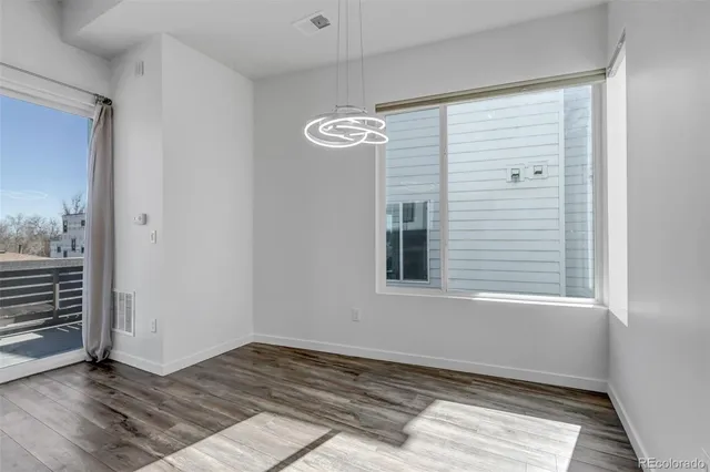a view of a hallway with wooden floor and entryway
