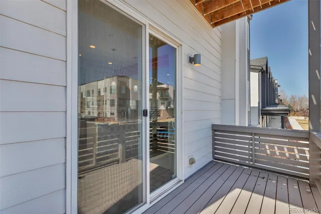 a view of a balcony with wooden floor and fence