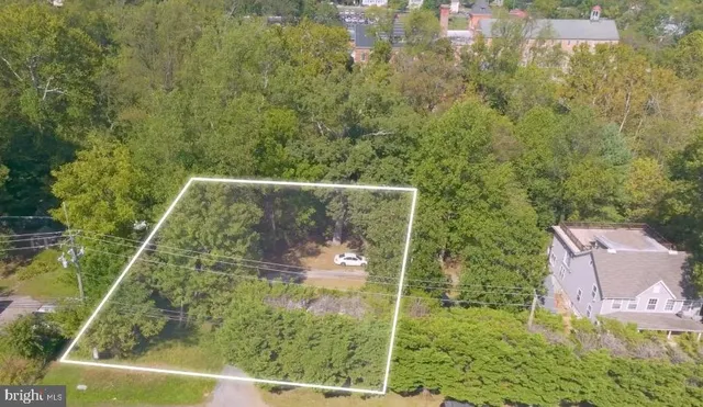 an aerial view of residential houses with outdoor space and river