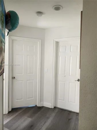 an empty room with wooden floor and closet