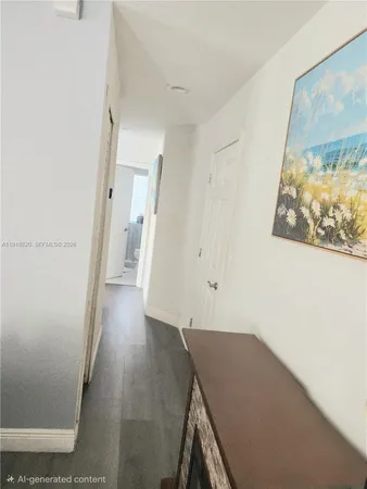 a view of a hallway with wooden floor and cabinet
