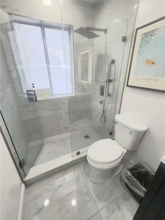 a white toilet sitting next to a bathroom sink