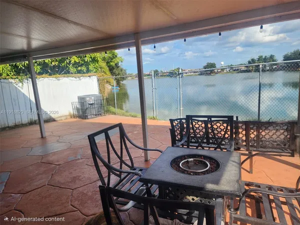 a view of a chairs and table in the patio