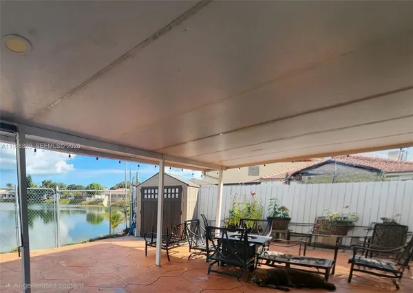 a patio with lake view and a garden