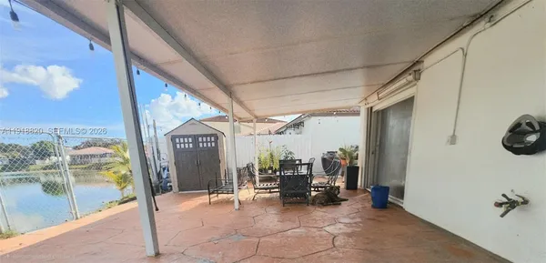a view of living room with furniture and floor to ceiling window