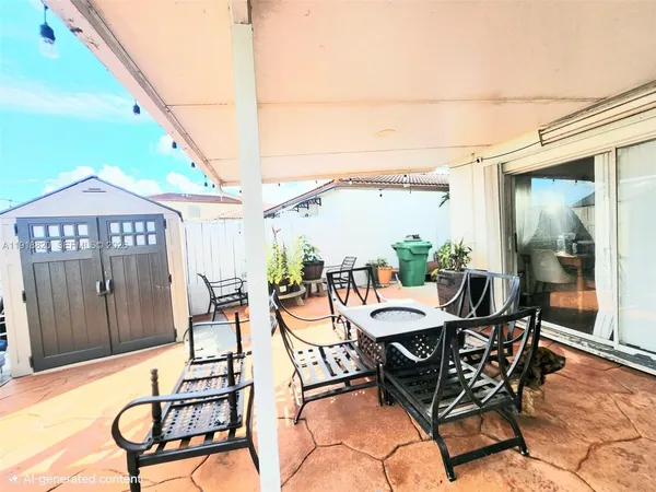 a view of a patio with a table and chairs