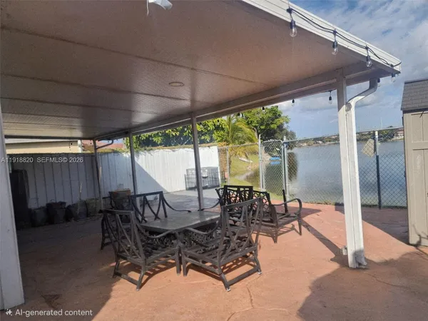a view of a patio with table and chairs next to a yard