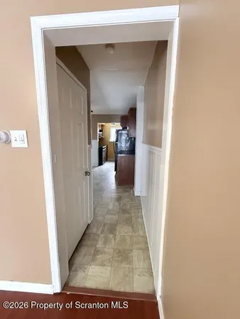 a view of a hallway with a wooden floor