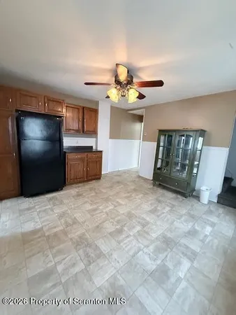 a view of an empty room with window and cabinet