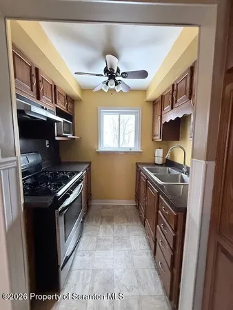 a kitchen with stainless steel appliances granite countertop a stove a sink and a refrigerator