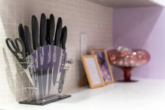 a kitchen with a stove and white cabinets
