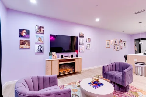 a living room with furniture and a lamp