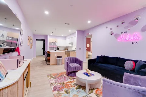 a living room with furniture and kitchen view