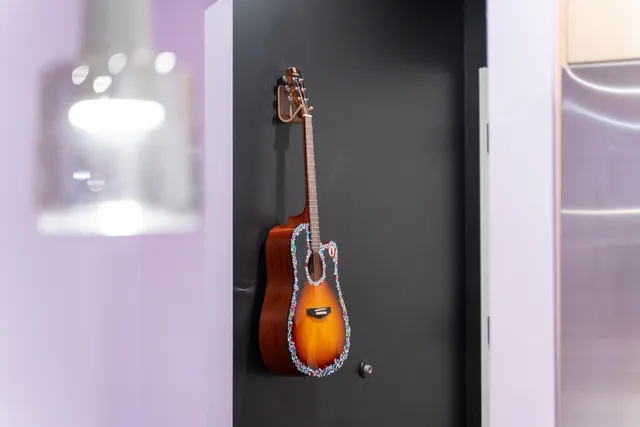 a bedroom with a bed and a painting on the wall