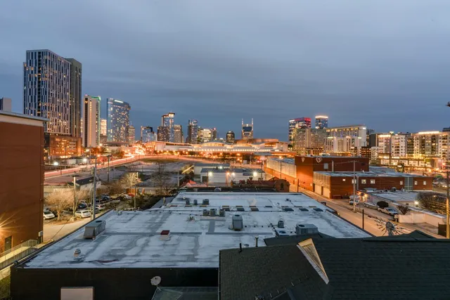 a view of a patio with couches table and chairs and potted plants