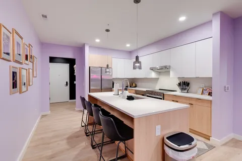 a kitchen with a stove a refrigerator and a sink