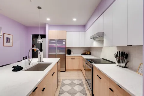 a kitchen that has a sink and a stove in it