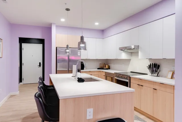 a kitchen with a sink a stove and cabinets