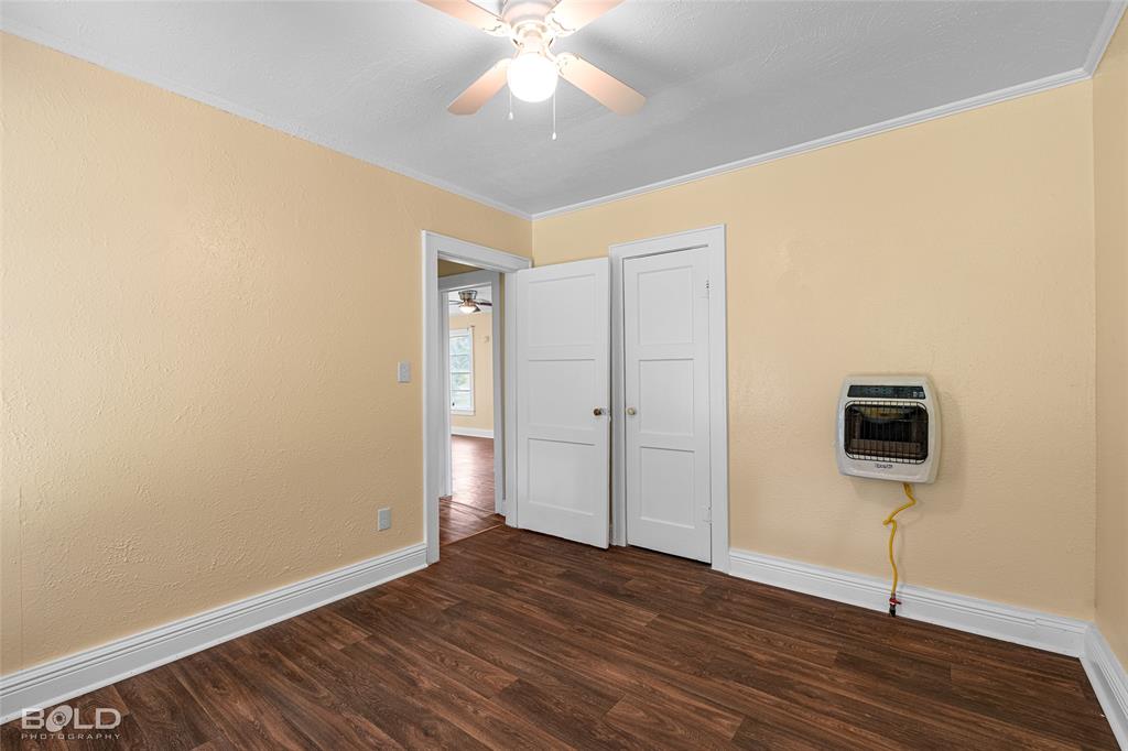 115 Pam Street Mansfield, LA 71052 - Photo 21 of 25 a view of an empty room with wooden floor and a ceiling fan