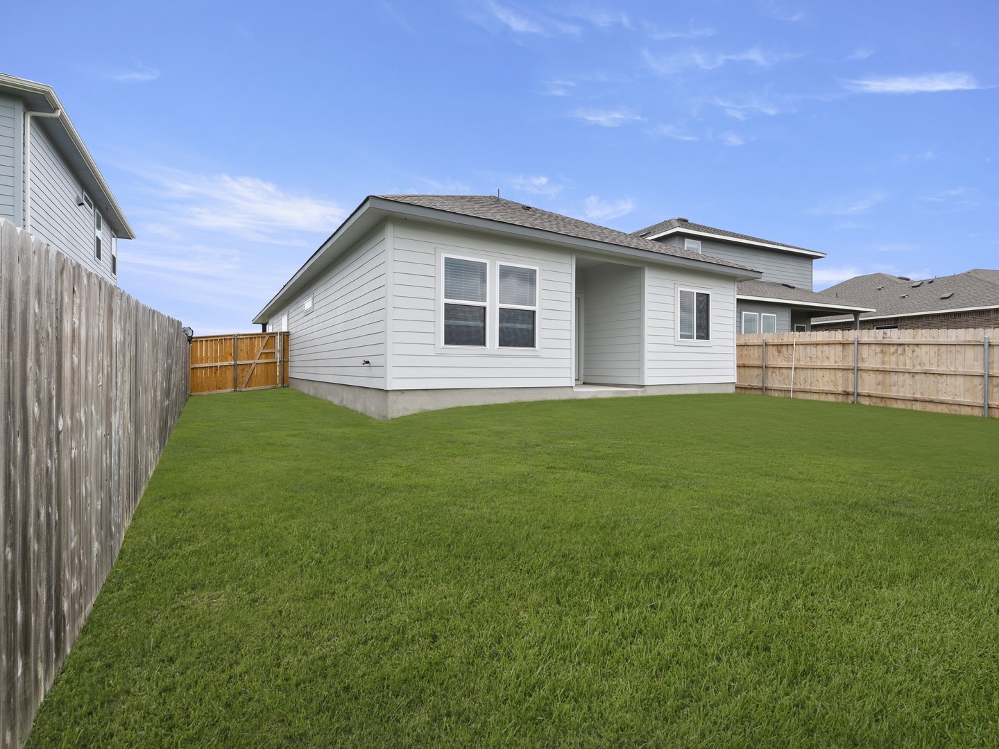 513 Yellow Ribbon Trail Jarrell, TX 76537 - Photo 19 of 23 A well-maintained lawn provides ample space for outdoor activities, enclosed by a privacy fence.