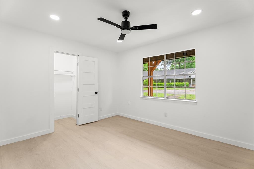 110 Hackberry Street Lancaster, TX 75146 - Photo 19 of 32 Light-filled room featuring wood-finish flooring, a contemporary ceiling fan, recessed lighting, a window with exterior views, and a closet with a five-panel door