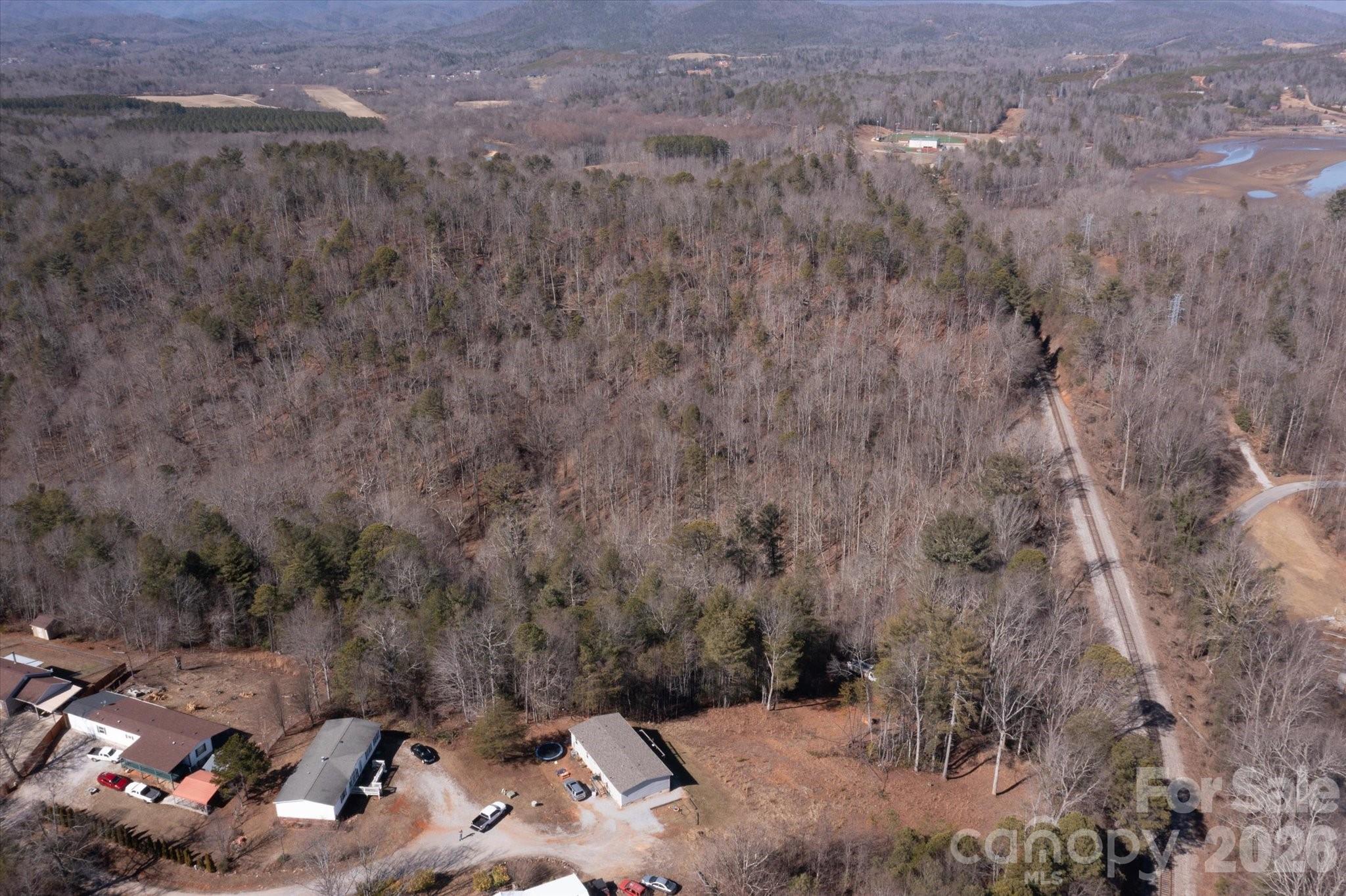 V/l V/l Ridge Walk Road, Unit 16 Marion, NC 28752 - Photo 9 of 10 a view of a dry yard with trees and houses