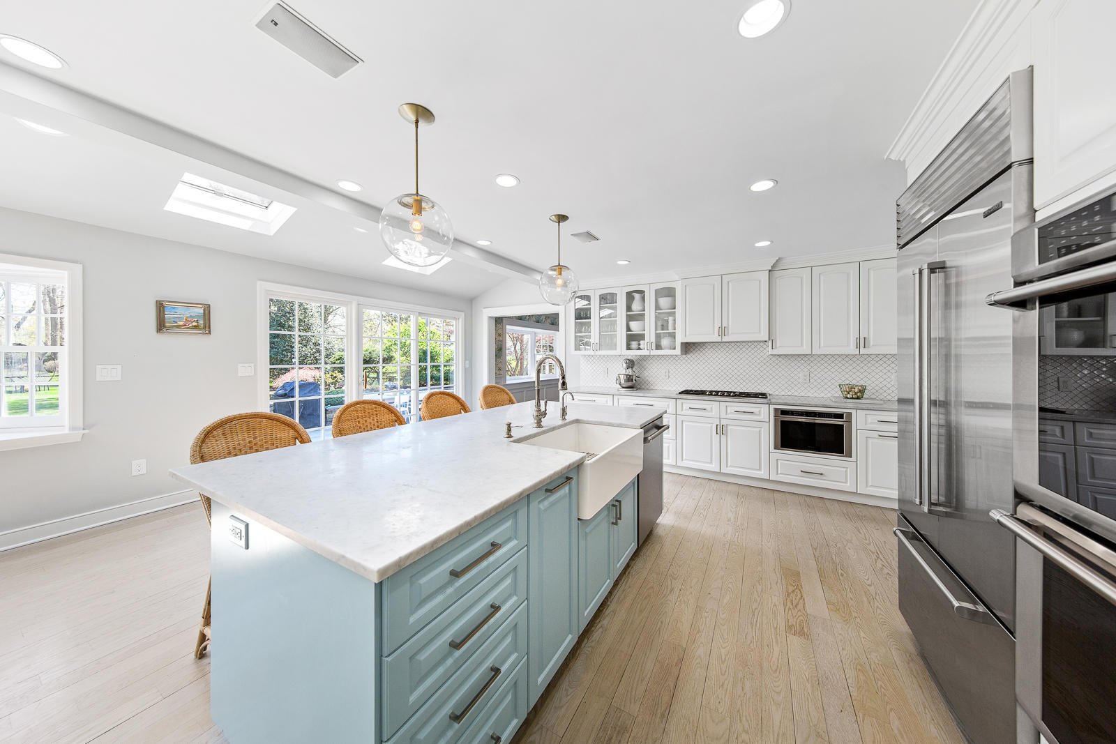 27 Searles Road Darien, CT 06820 - Photo 17 of 56 a kitchen with counter top space a sink stainless steel appliances and windows