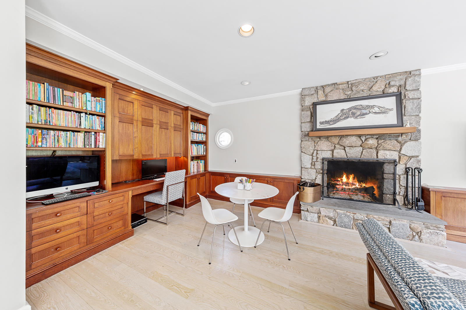 27 Searles Road Darien, CT 06820 - Photo 22 of 56 a living room with furniture a flat screen tv and a fireplace