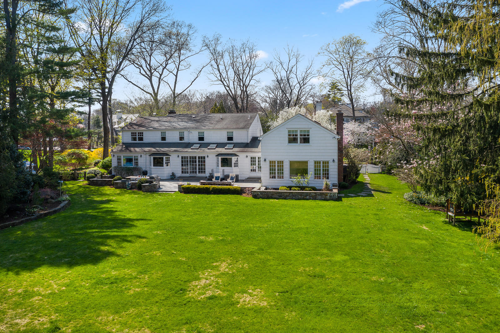 27 Searles Road Darien, CT 06820 - Photo 43 of 56 a front view of a house with a garden and trees