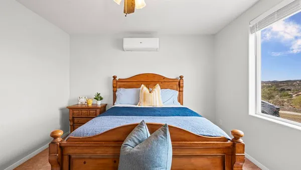 a bedroom with a bed and window