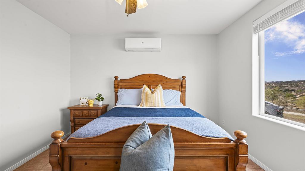 39260 Grassy Road Temecula, CA 92592 - Photo 14 of 50 a bedroom with a bed and window