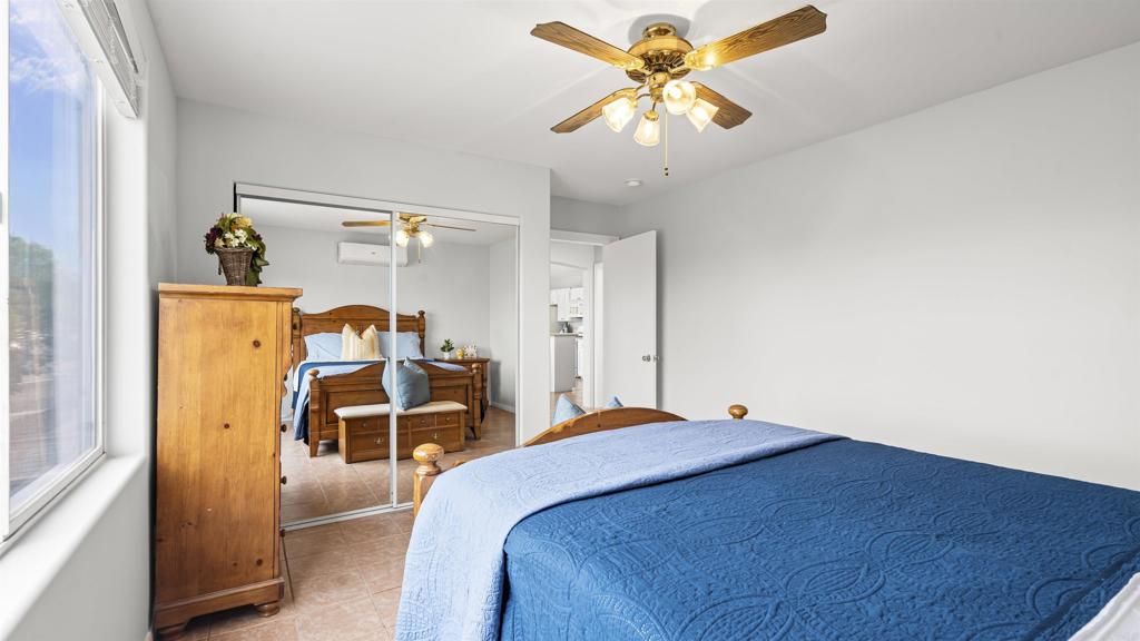 39260 Grassy Road Temecula, CA 92592 - Photo 15 of 50 a bedroom with a bed and a chandelier