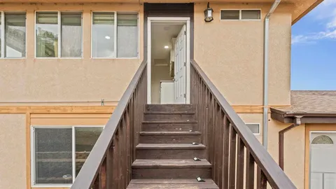 a view of entryway with wooden floor and a front door