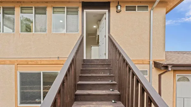 a view of entryway with wooden floor and a front door