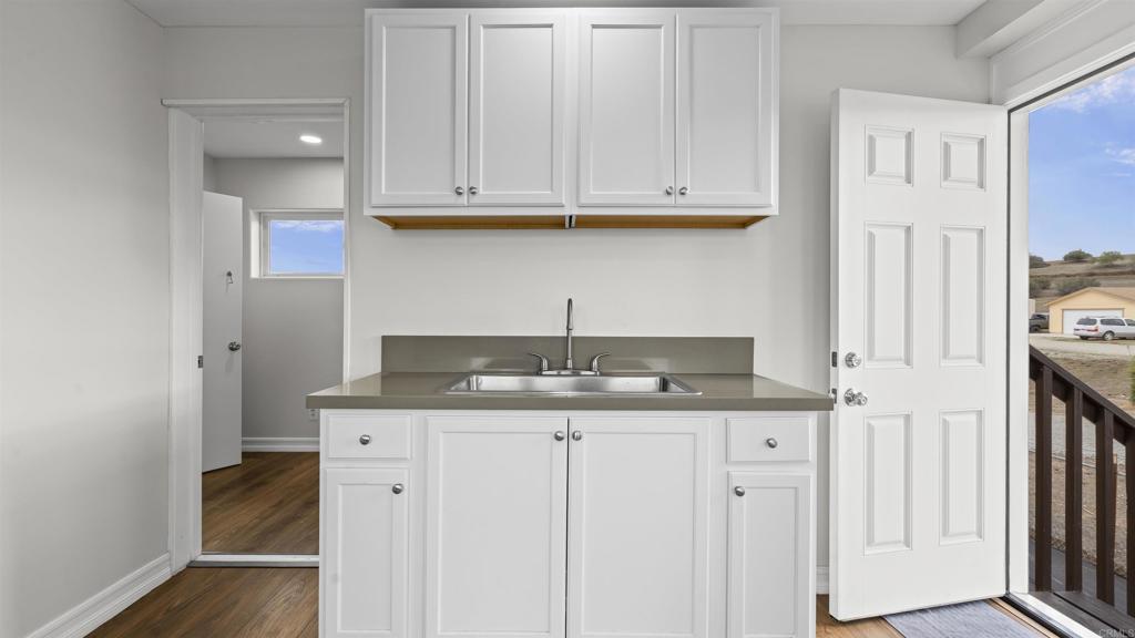 39260 Grassy Road Temecula, CA 92592 - Photo 24 of 50 a kitchen with granite countertop a sink and cabinets