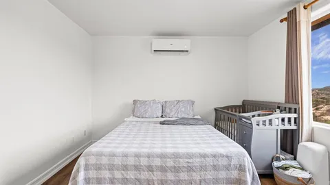 a bedroom with a bed and a window