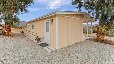 a view of a house with a backyard