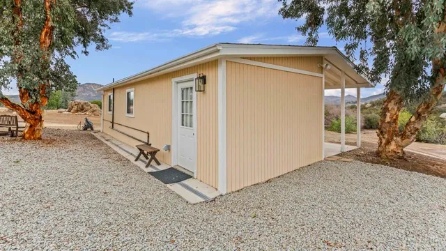 a view of a house with a backyard
