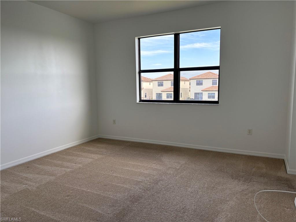5414 Ferris Avenue Ave Maria, FL 34142 - Photo 8 of 15 Unfurnished room featuring light carpet and baseboards